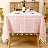AIMHave vintage pink floral linen look tablecloth featuring elegant white blossoms with white tassels on a rustic table