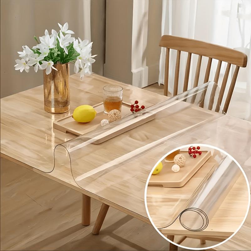 Clear PVC table protector protecting a wooden dining table