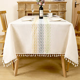 AIMHave modern farmhouse tablecloth featuring woven yellow, blue, and green wheat ear stripes down the center of an oatmeal dining table