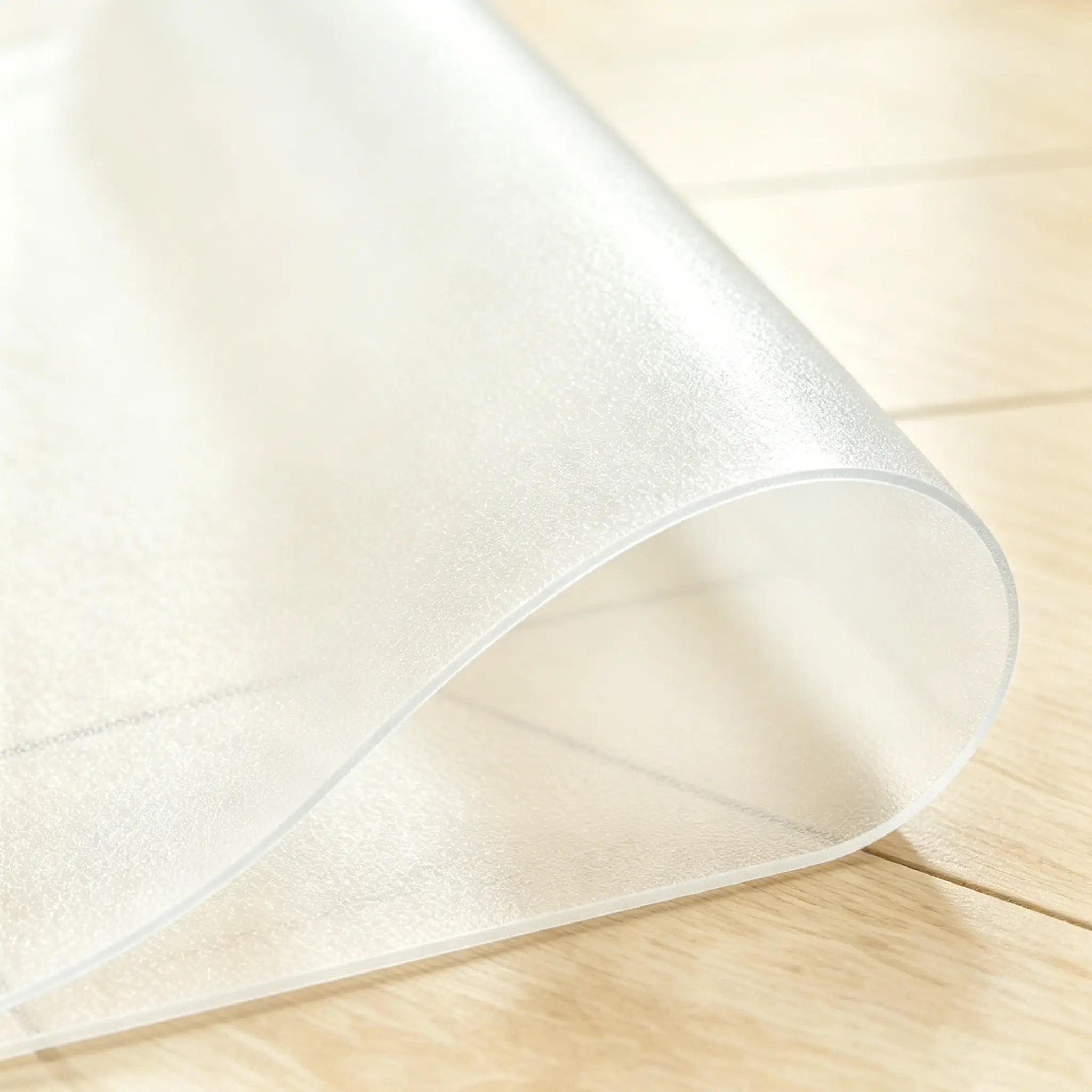 Close-up of frosted PVC mat being folded to demonstrate high flexibility and non-toxic, pet-friendly quality.