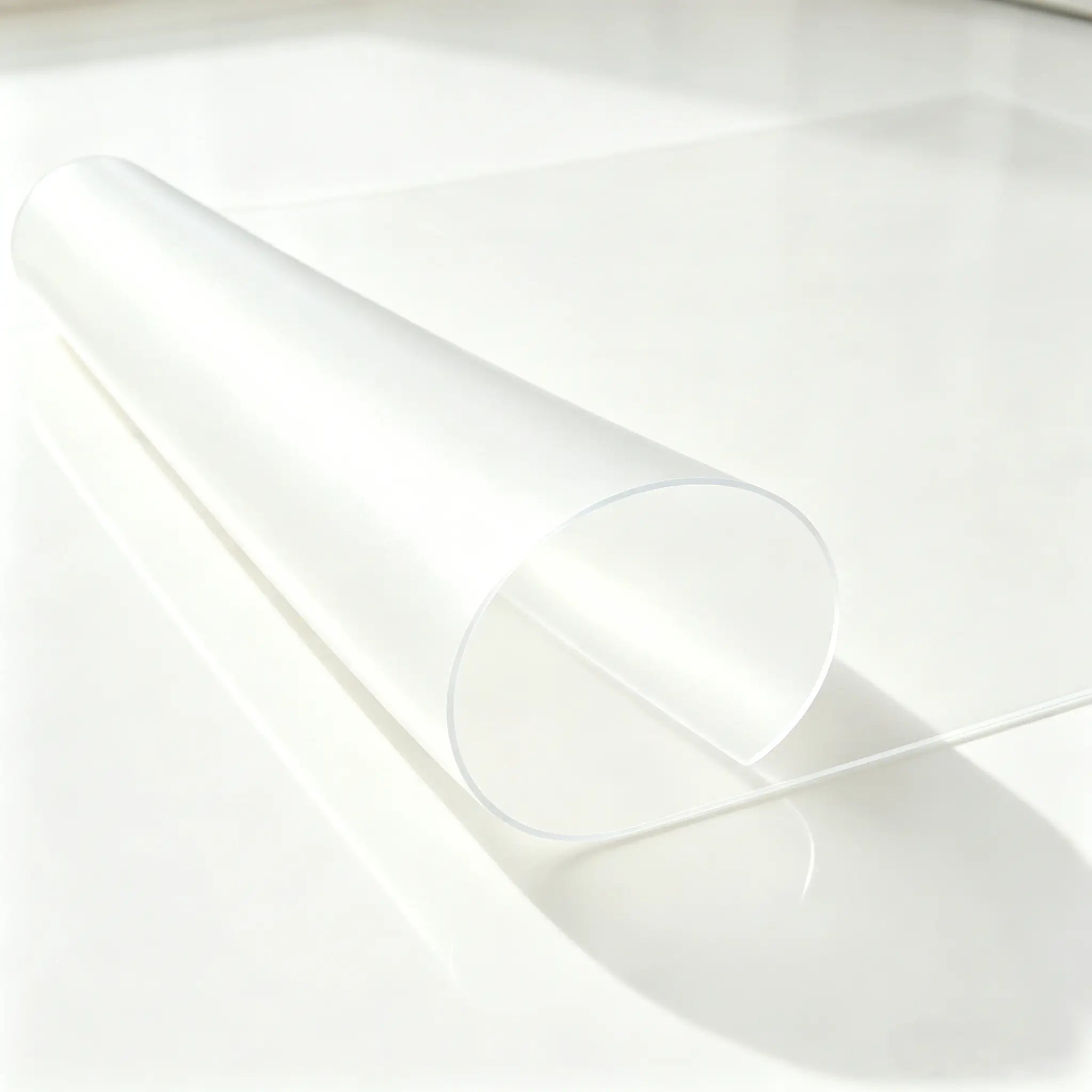 Frosted PVC bathroom mat with curved edge to show its soft texture and stay-flat design on wet tile floors.