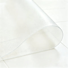Close-up of frosted PVC bathroom mat being folded in the middle to demonstrate high flexibility and durability.