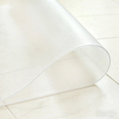 Close-up of frosted PVC entrance mat being folded in the middle to demonstrate high flexibility and durability.