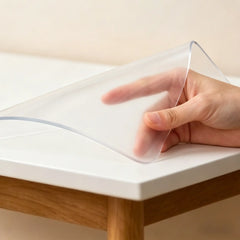 Hand pinching and folding a frosted office mat to demonstrate high flexibility and premium soft PVC quality.