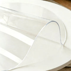 Round clear PVC mat showing high transparency and durability with a flexible center bend for easy handling.