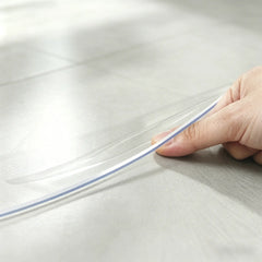 Close-up of round PVC mat edge being pinched to show 1.5mm thickness and crystal clear, high-quality material.