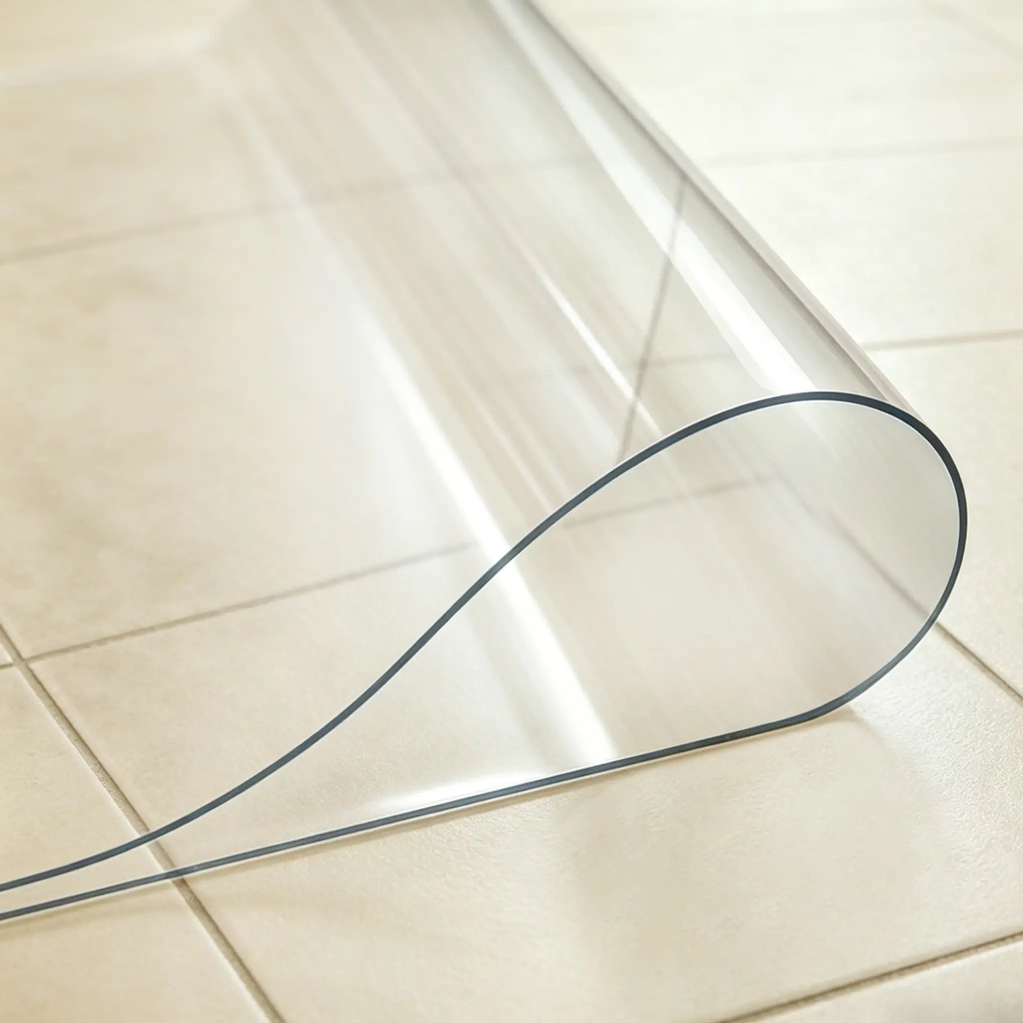 Close-up of transparent PVC laundry mat being folded in the middle to demonstrate durability and soft texture.