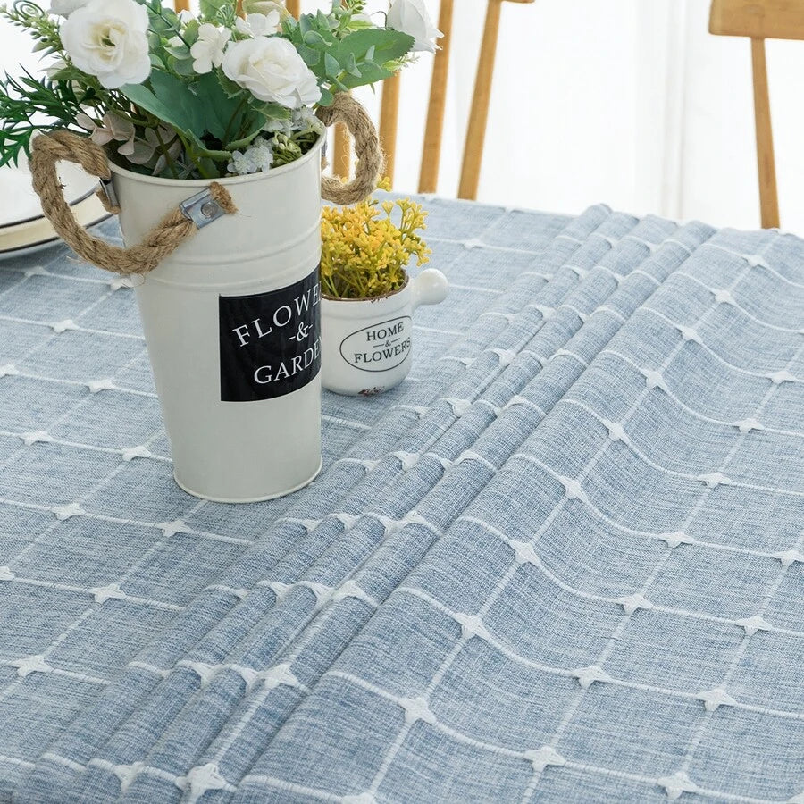 Cozy sunlit dining room table styled with an AIMHave vintage blue floral tablecloth featuring white tassels and a flower vase