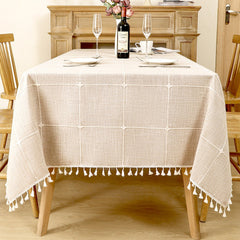 Classic grey and beige striped linen look tablecloth with white tassels on a farmhouse wooden dining table