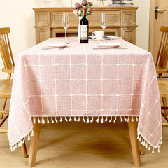 AIMHave vintage pink floral linen look tablecloth featuring elegant white blossoms with white tassels on a rustic table