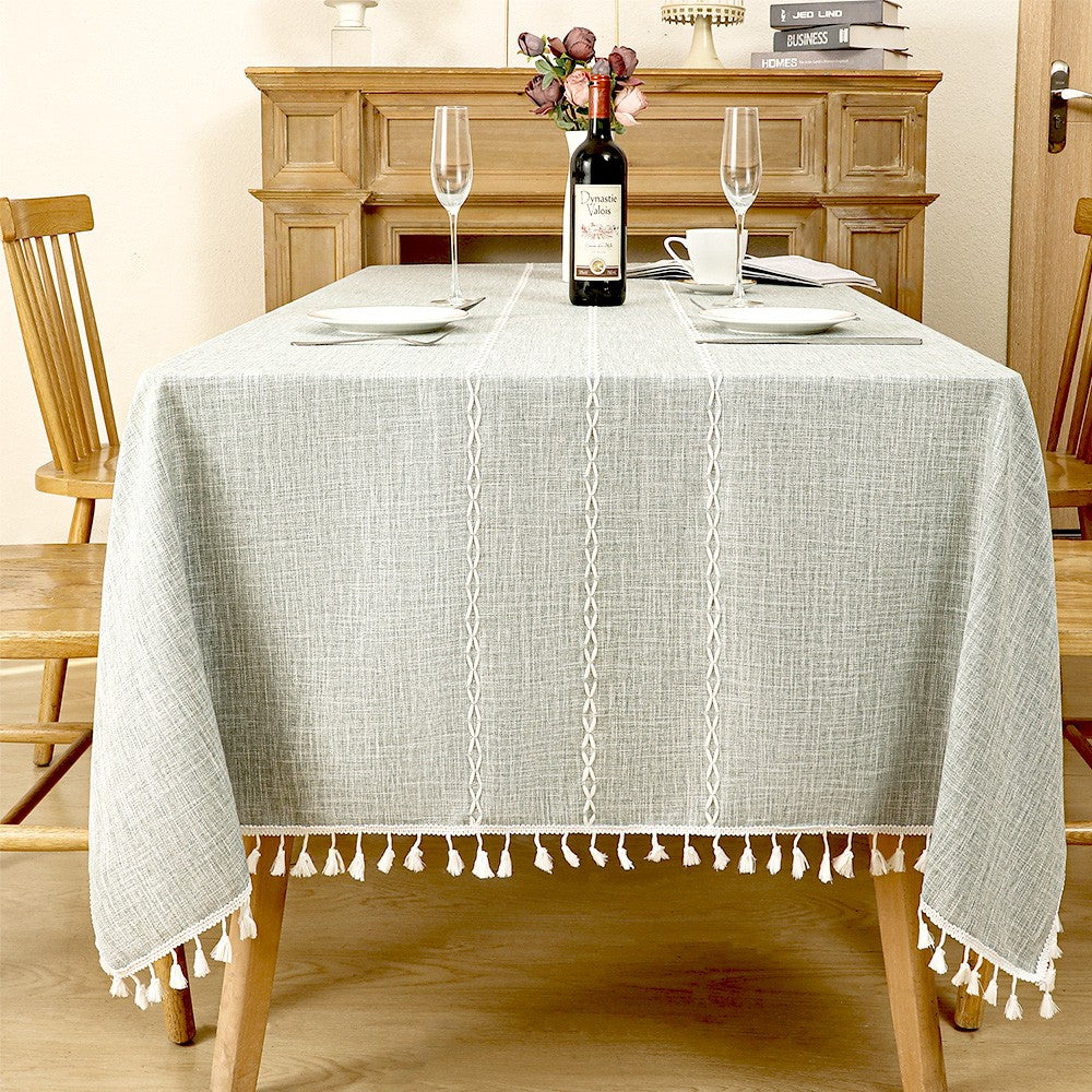 AIMHave modern large windowpane plaid linen look tablecloth featuring oversized grey and white checks with tassels on a dining table