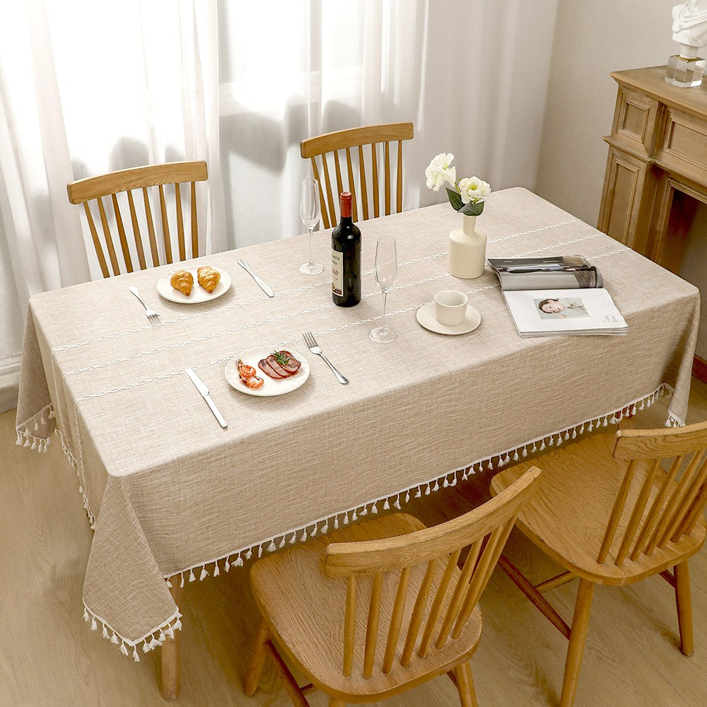Top view of AIMHave heavyweight rustic farmhouse checkered coffee brown poly-cotton tablecloth styled with plates and croissants