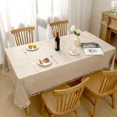 Top view of AIMHave heavyweight rustic farmhouse checkered coffee brown poly-cotton tablecloth styled with plates and croissants