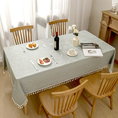 Top view of AIMHave heavyweight industrial farmhouse checkered grey poly-cotton tablecloth styled with plates and croissants