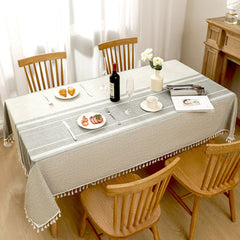 Top view of AIMHave modern southwestern boho grey poly-cotton tablecloth styled with plates and croissants