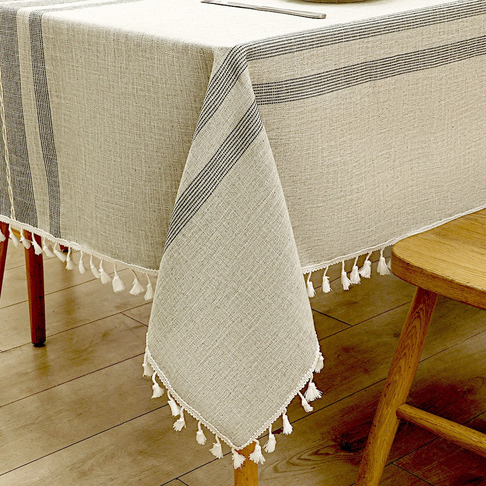 Close-up of elegant white macrame fringe tassels on an AIMHave grey geometric diamond lattice faux linen tablecloth