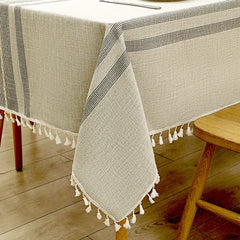 Close-up of elegant white macrame fringe tassels on an AIMHave grey geometric diamond lattice faux linen tablecloth