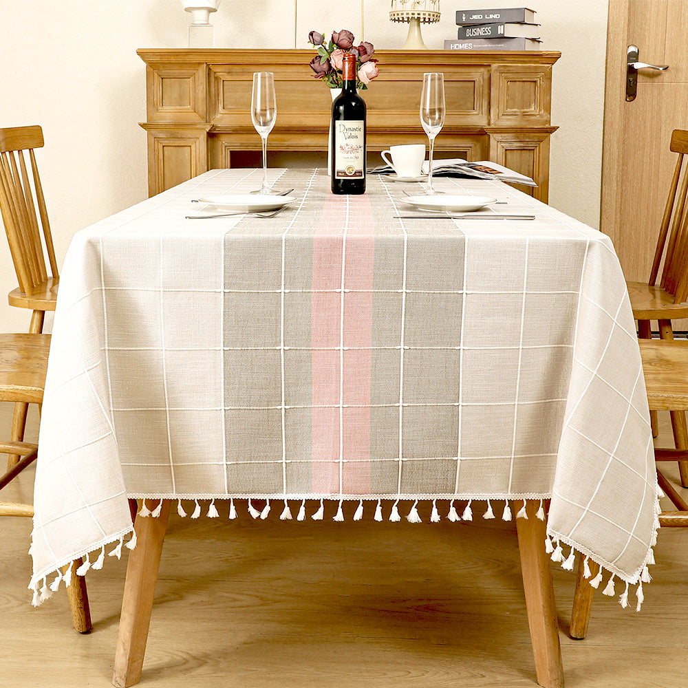 AIMHave modern abstract wave linen look tablecloth featuring fluid pink grey and white geometric shapes with white tassels on a dining table