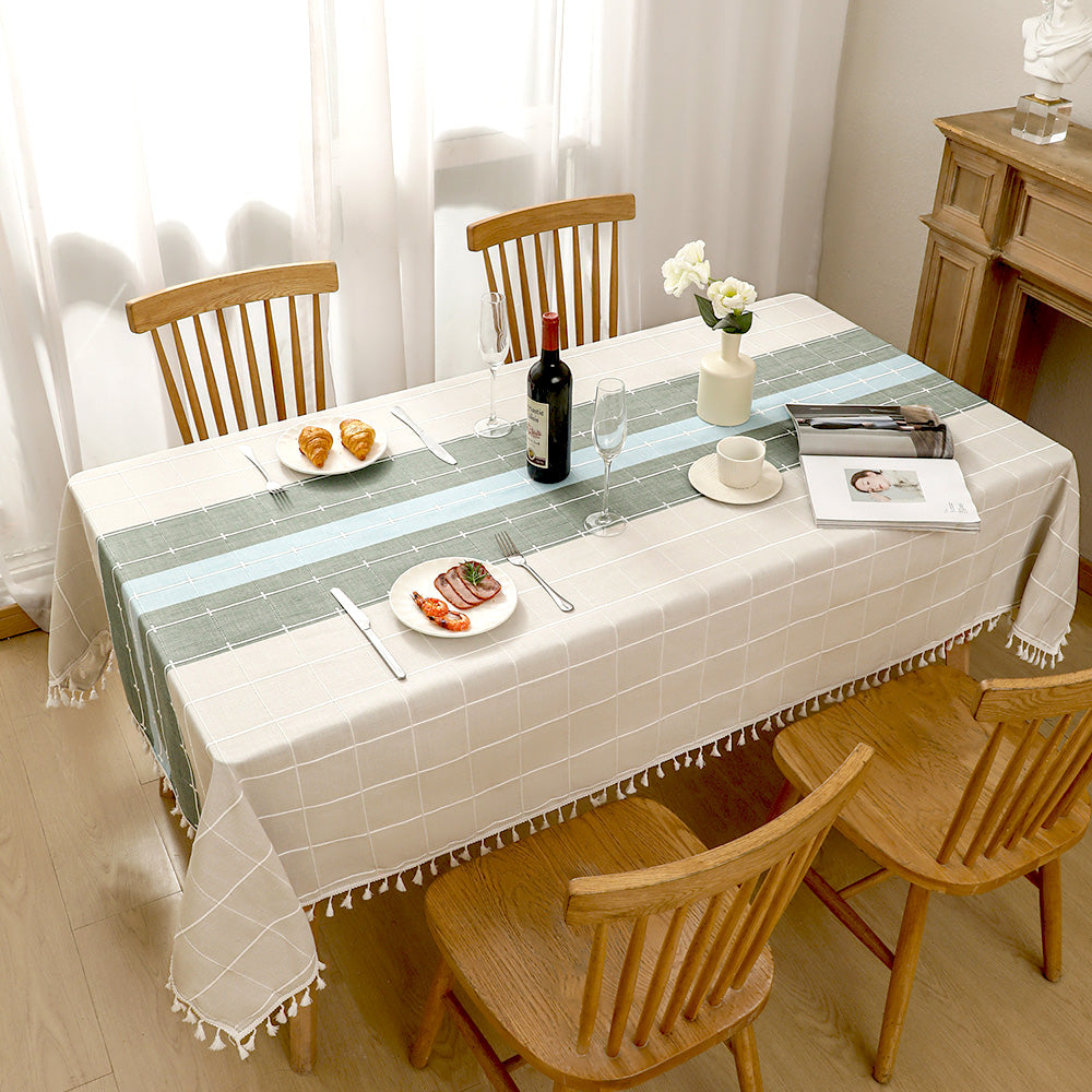 Top view of AIMHave luxury abstract fluid wave patchwork blue poly-cotton tablecloth styled with plates and croissants