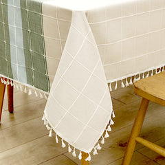 Close-up of elegant white macrame fringe tassels on an AIMHave indigo and blue abstract wave faux linen tablecloth