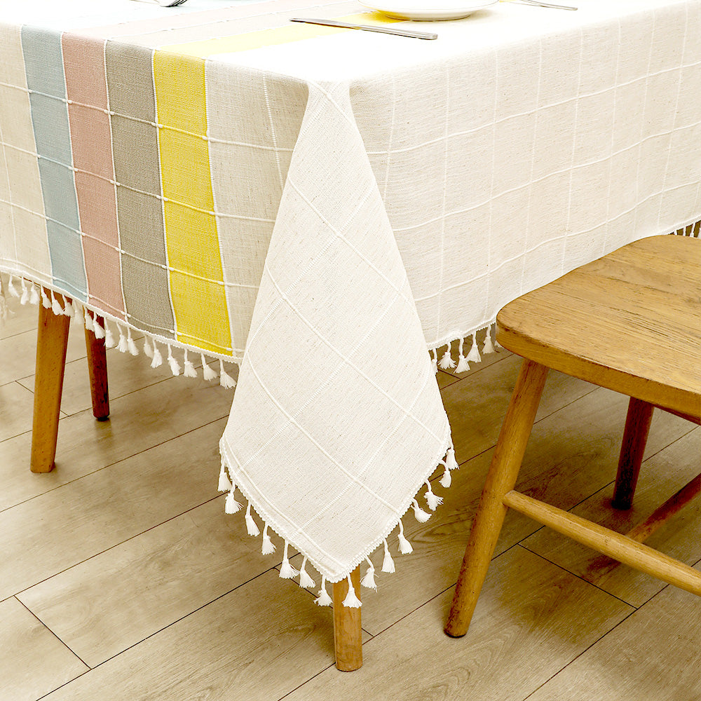 Close-up of elegant white macrame fringe tassels on an AIMHave colorful abstract wave faux linen tablecloth