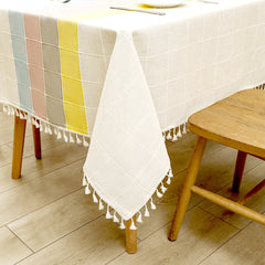 Close-up of elegant white macrame fringe tassels on an AIMHave colorful abstract wave faux linen tablecloth