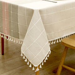 Close-up of elegant white macrame fringe tassels on an AIMHave pink and grey abstract wave faux linen tablecloth