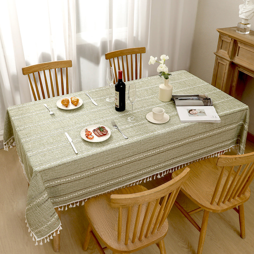 Top view of AIMHave elegant minimalist linear green poly-cotton tablecloth styled with plates and croissants