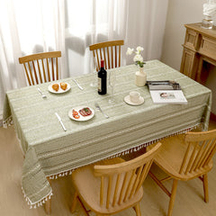 Top view of AIMHave elegant minimalist linear green poly-cotton tablecloth styled with plates and croissants