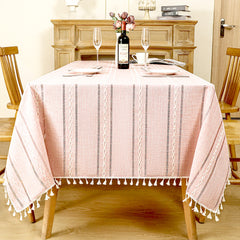 AIMHave modern vertical stripe linen look tablecloth featuring multi-width pink and white lines with tassels on a dining table
