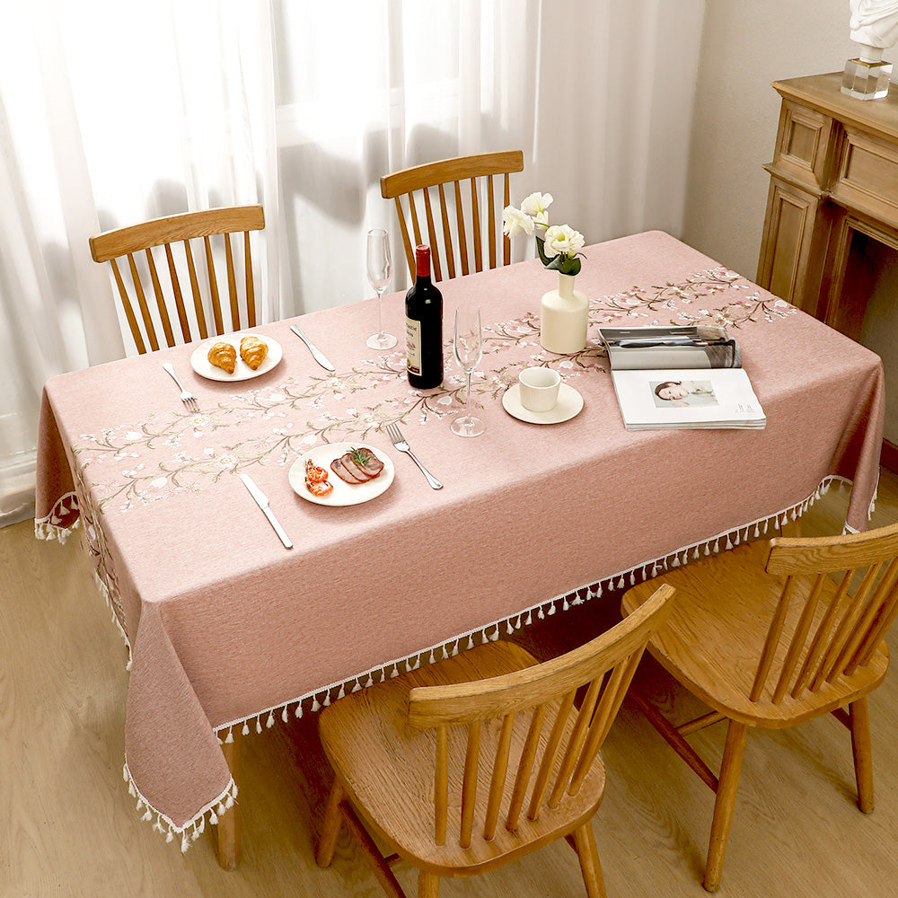 Top view of AIMHave elegant blush pink faux linen tablecloth with symmetrical flower embroidery styled with wine and croissants