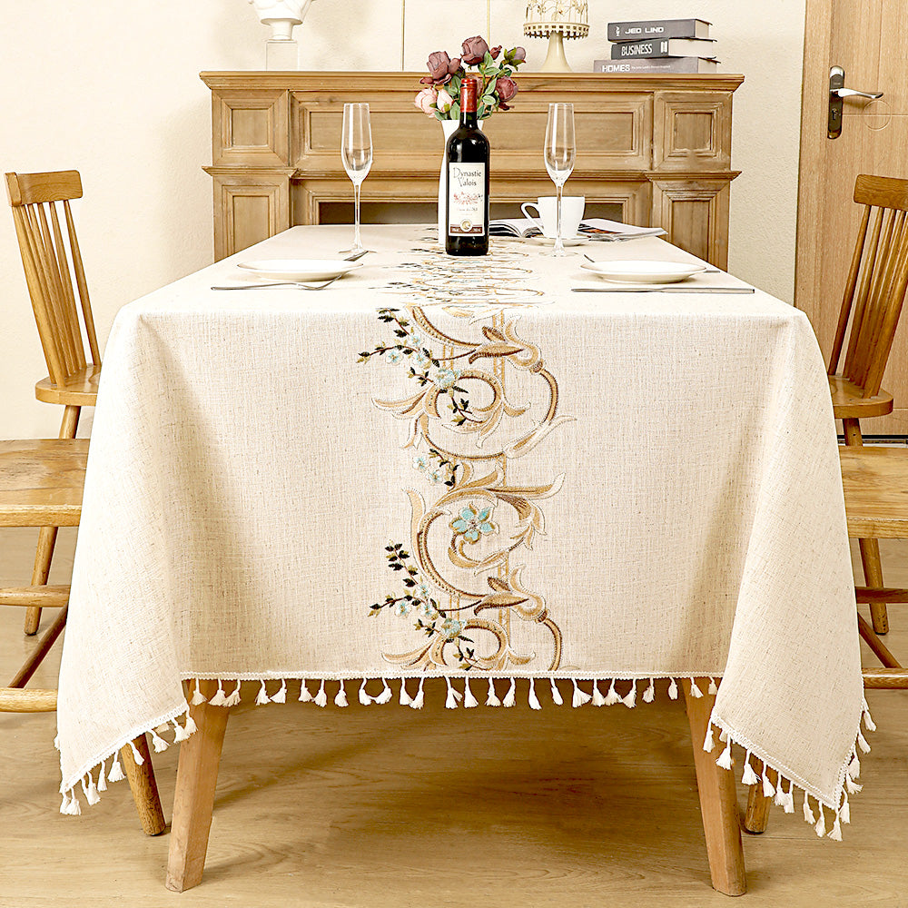 AIMHave traditional luxury tablecloth featuring embroidered gold and light blue baroque scrollwork down the center of an oatmeal dining table