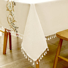 Close-up of elegant white macrame fringe tassels on an AIMHave luxury baroque gold and light blue embroidered tablecloth