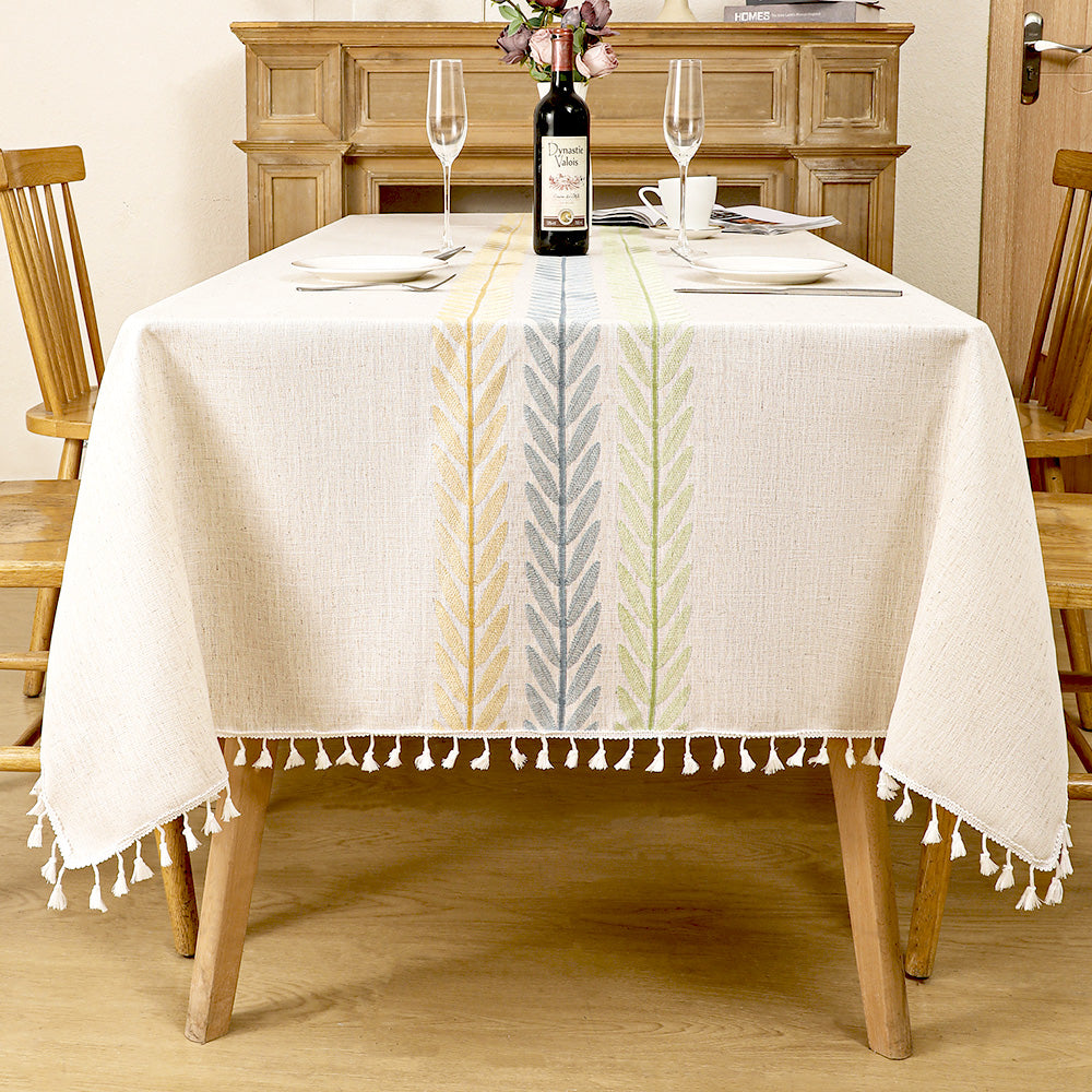 AIMHave modern farmhouse tablecloth featuring woven yellow, blue, and green wheat ear stripes down the center of an oatmeal dining table
