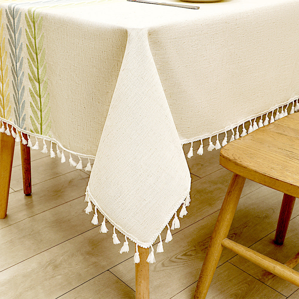 Close-up of elegant white macrame fringe tassels on an AIMHave colorful wheat ear harvest pattern faux linen tablecloth