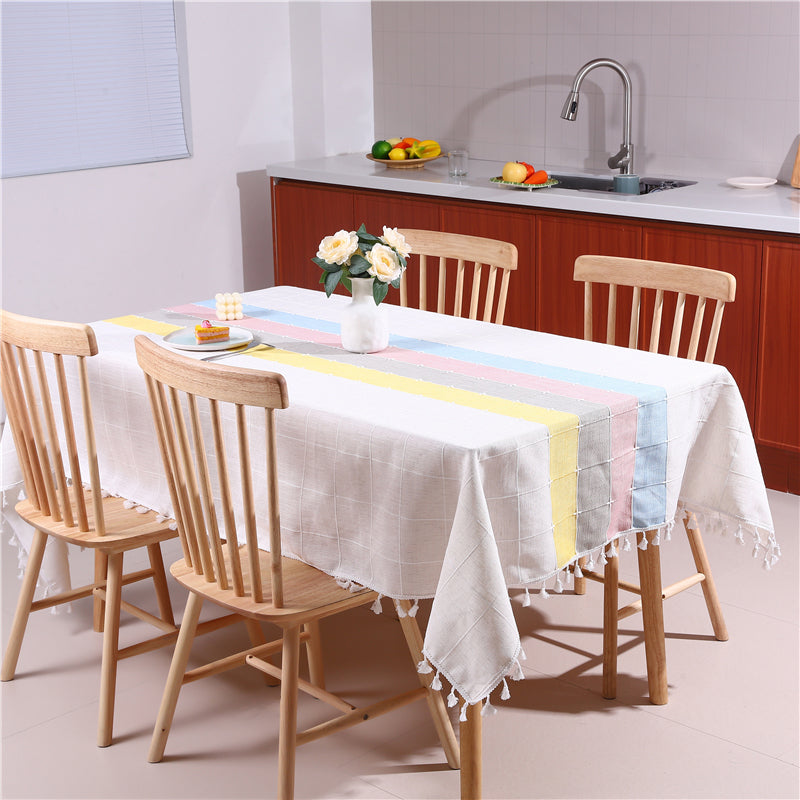 Bright and modern dining room table styled with an AIMHave contemporary abstract vibrant pastel multi-color tablecloth featuring a flower vase