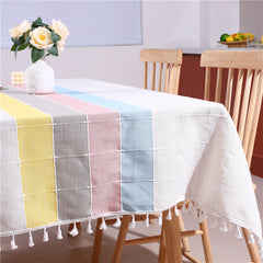 Bright and modern dining room table styled with an AIMHave contemporary abstract vibrant pastel multi-color tablecloth featuring a flower vase