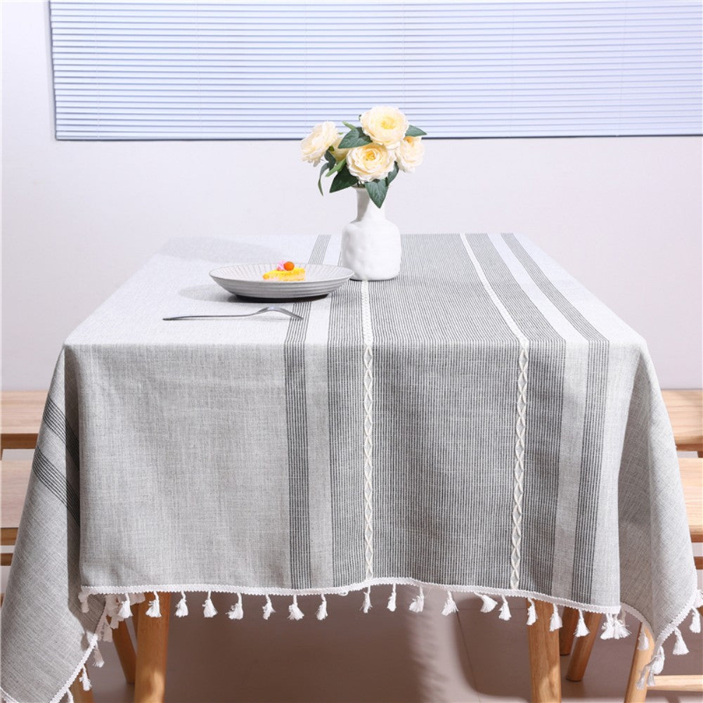 Cozy light-filled dining room table styled with an AIMHave modern Moroccan geometric tablecloth featuring white tassels and a white flower vase