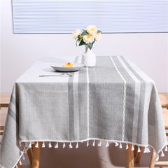 Cozy light-filled dining room table styled with an AIMHave modern Moroccan geometric tablecloth featuring white tassels and a white flower vase