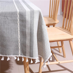 Cozy light-filled dining room table styled with an AIMHave modern Moroccan geometric tablecloth featuring white tassels and a white flower vase