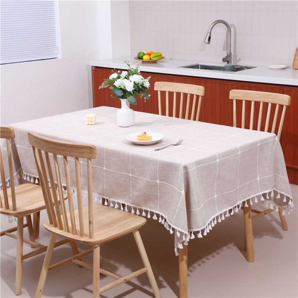 Warm coffee striped farmhouse table cover with tassels featuring a white flower vase and a calendar card
