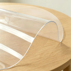 Round clear PVC mat showing 1.5mm material flexibility and high transparency for dining room table protection.