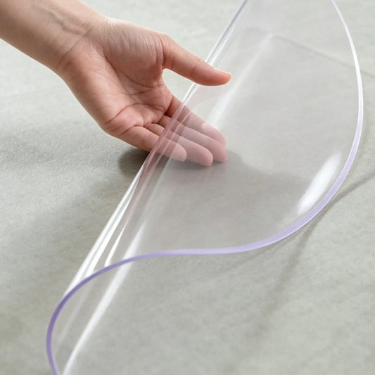 Hand folding a round clear PVC mat to show high flexibility, ensuring the mat stays flat and won't curl.