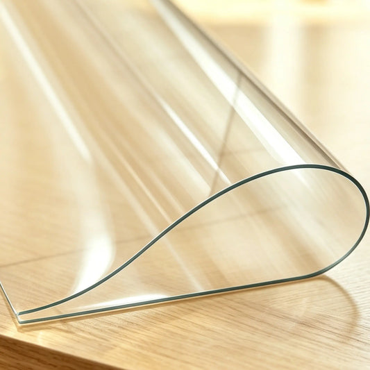 Close-up of PVC table pad showing material thickness and flexible edges for safe use.