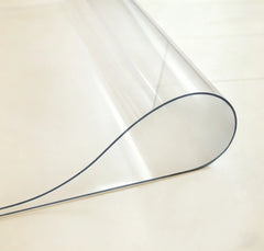 Close-up of transparent PVC bathroom mat being folded in middle to show durable, soft texture for wet floors.